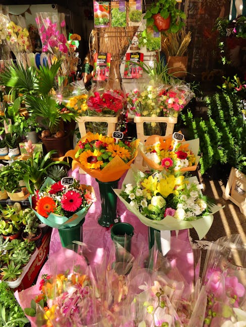 A vibrant display of fresh floral bouquets arranged on a pink cloth-covered stand at Ardleigh Green Flowers, a top florist on Ardleigh Green Road. The arrangement features a variety of colorful flower